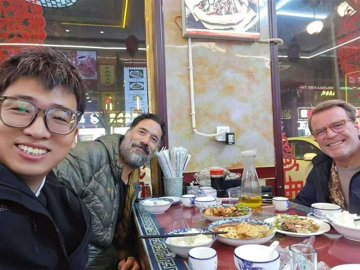 Tiger the local guide with 2 guests at table